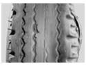 Cassure du flanc du pneu et de la nappe carcasse, accompagnant le déchirement d’éléments de la sculpture de la bande de roulement du pneu.